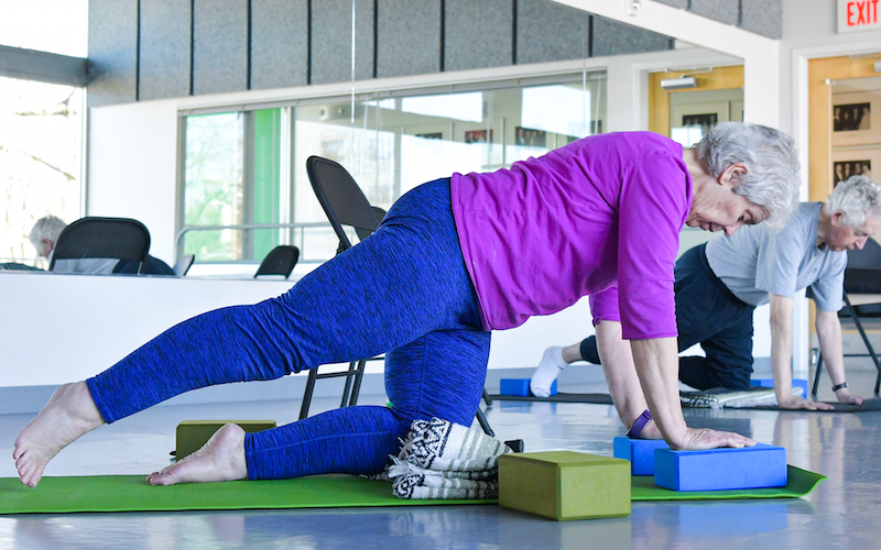 A PMI student in a pilates pose
