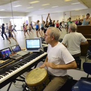 Jefferson Dalby playing the drums for a dance class