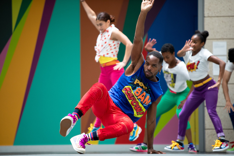 Dancers in brightly colored outfits
