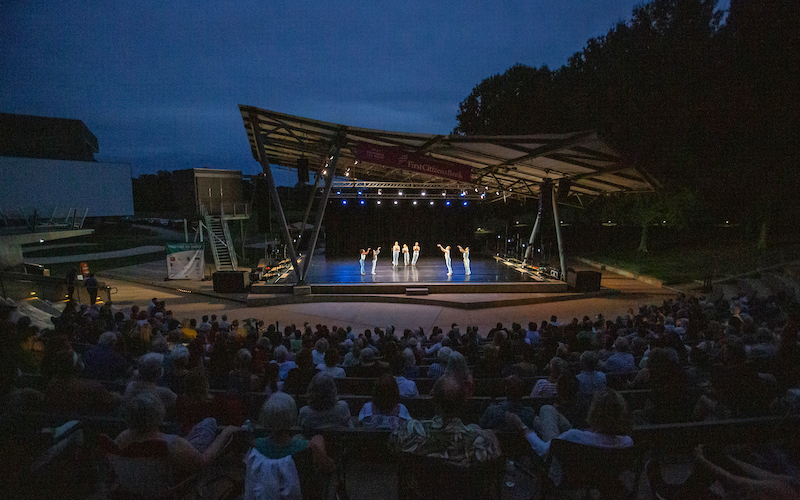 Outdoor stage with a large audience at night