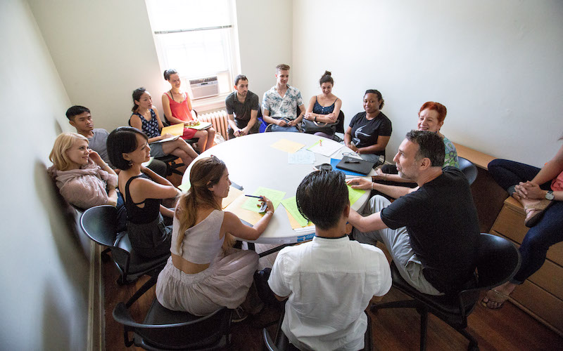 Artists in the International Choreographers Residency having a discussion around a table