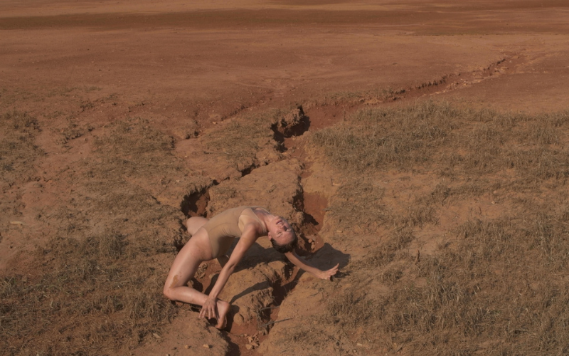 A performer posing in a desert